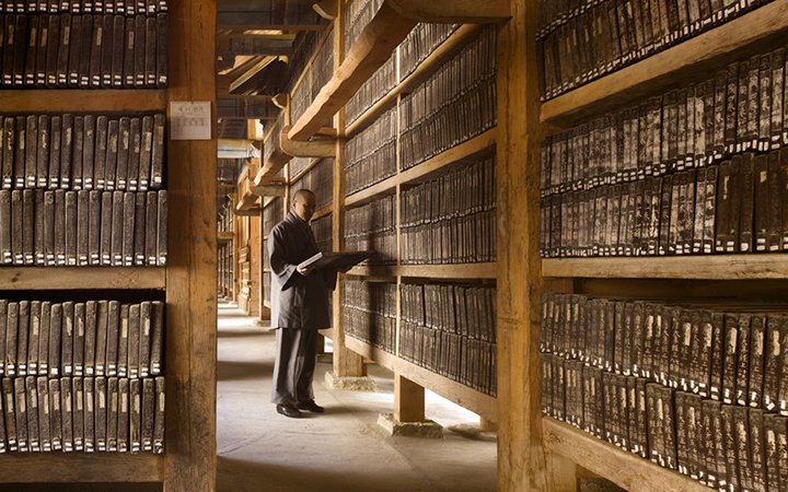 BOOK: THE LIBRARY A WORLD HISTORY ONY TO BE USED IN RELATION TO THE BOOK OTHERWISE PERMISSION NEEDED FROM PHOTOGRAPHER p62-63 The Tripitaka Koreana, 1251 Haeinsa Temple, South Korea This view shows the inside of the longer of the two halls that house the Tripitaka Koreana. The blocks are stored in open racks to allow the air to circulate freely around them. The timber structure is lifted off the floor on pad stones and the building is raised on a stone plinth surrounded by drainage channels p.62-63 Will Pryce.jpg